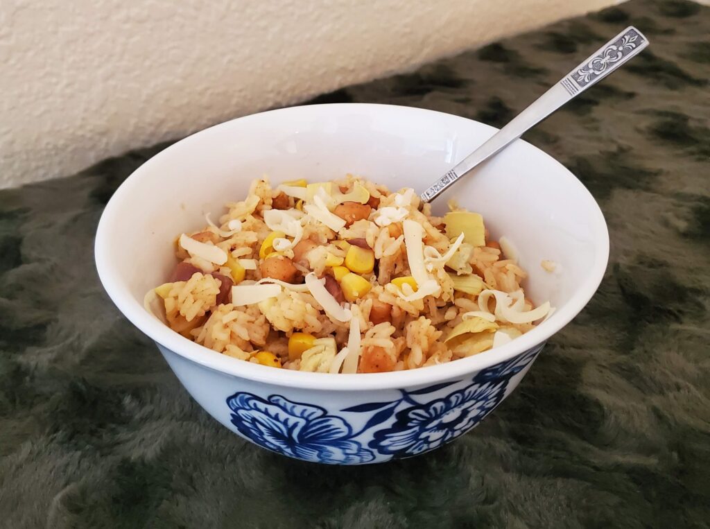 Green background with a display of the chickpea artichoke rice bowl meal.